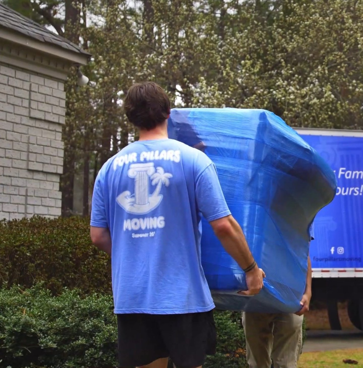 Four Pillars Moving crew loading a moving truck
